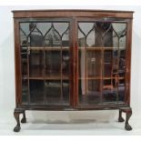 20th century mahogany bowfront display cabinet with two astragal glazed doors enclosing shelves,