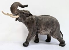 Beswick tinted bisque porcelain model of elephant with trunk raised, 41cm wide overall