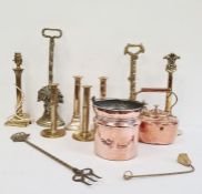Various 19th century highly polished brass door stops, copper kettle, various brass candlesticks,