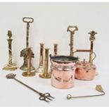 Various 19th century highly polished brass door stops, copper kettle, various brass candlesticks,