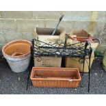 A quantity of terracotta pots, watering cans and pot stand