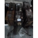 Two vintage leather suitcases, one with various travel labels, another suitcase and two boxes of