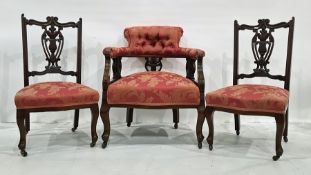 Victorian mahogany-framed salon chair with red ground foliate patterned upholstery and two similarly