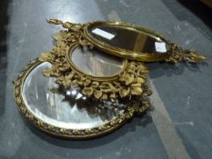 Three various gilt-framed mirrors, a pair of brass mirrored electric light sconces, a another pair