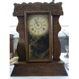 Late 19th/early 20th century American mantel clock in carved Art Deco style oak case, the movement