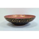 Royal Worcester porcelain shallow bowl, matt black glazed with gilt foliate border to exterior,