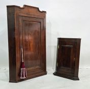 19th century oak wall-hanging corner cupboard with single door enclosing shelves and one further (2)