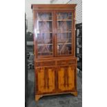 20th century yew bookcase cabinet with dentil cornice above astragal glazed doors enclosing shelves,