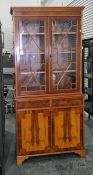 20th century yew bookcase cabinet with dentil cornice above astragal glazed doors enclosing shelves,