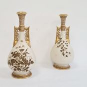 A Pair of Royal Worcester ivory ground Persian-style vases, of baluster shape with elongated