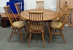 Light elm Ercol drop-leaf table raised on beech supports and a set of six Ercol light elm seated and