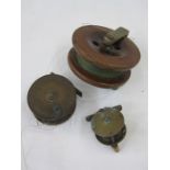 Brass and wood fishing reel, another brass fishing reel smaller and a larger wood and brass