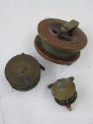 Brass and wood fishing reel, another brass fishing reel smaller and a larger wood and brass