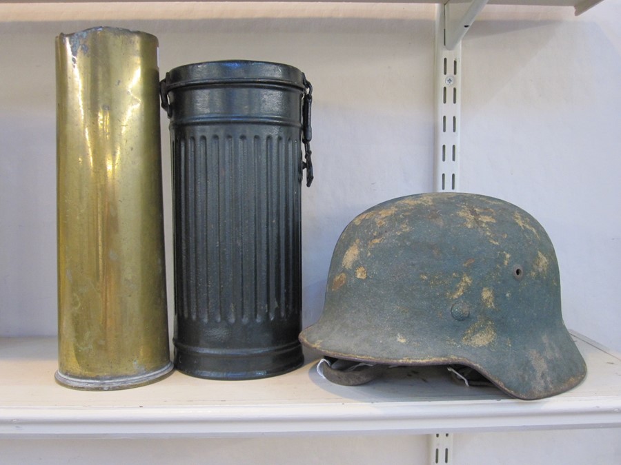 WW2 German Helmet with original paint and leather liner, WW2 German gas mask case and WW2 shell case