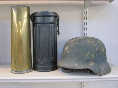 WW2 German Helmet with original paint and leather liner, WW2 German gas mask case and WW2 shell case