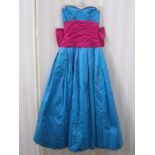 Bernshaw ball gown in turquoise and shocking pink taffeta, strapless with huge bow to the back and