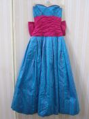 Bernshaw ball gown in turquoise and shocking pink taffeta, strapless with huge bow to the back and