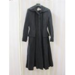 A black 1950's evening coat labelled Verner Vogue Francis Stuart Piccadilly, half peplum, fitted