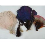 A purple feather and tortoiseshell fan, 19cm, a tortoiseshell and pink/grey feather fan, a wooden