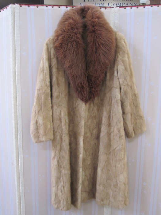 A blond mink full-length coat with a dyed fox fur collar, the lining hexagonal pattern to match