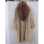 A blond mink full-length coat with a dyed fox fur collar, the lining hexagonal pattern to match