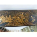 An oriental lacquered glove box, black with gilt decoration to lid, depicting seated figures in an