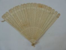 A 19th century Chinese bone fan, shallow relief decorated with central oval motif with initials