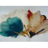 A turquoise and bakelite ostrich feather fan, a white ostrich feather fan and another multi coloured