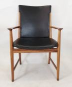 Circa 1960's/70's rosewood framed armchair with black vinyl seat and back, on circular supports