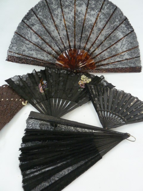 A tortoiseshell (?) and black lace fan, a wooden and black lace fan, a black wooden fan with painted