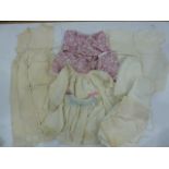 Quantity of babygowns, to include silk with smocking, matching knickers, cream wool wool jacket