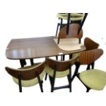 A G-plan Librenza teak dining table on ebonised legs, a set of six G-plan butterfly teak and