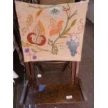 A small folding beach/ picnic vintage chair, with an embroidered linen back