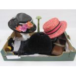Vintage black straw hat with net detail, faux-flowers and a leaf, a pink straw boater labelled 'Miss