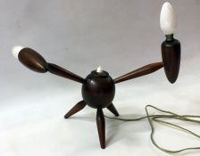 A 20th Century wooden table lamp, two arms on a circular body on three splayed legs