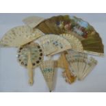 Two pierced bone and painted fans, a miniature pierced bone fan and various ivory type fans, some
