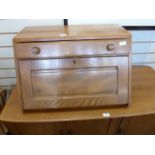 Ercol elm table top bureau with fall-front, single drawer above with circular handles, curved bar