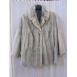 Silver mink jacket with scalloped hem, two button fastening and the sleeves with scallop edge