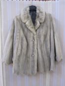 Silver mink jacket with scalloped hem, two button fastening and the sleeves with scallop edge