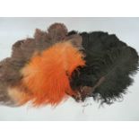 A black ostrich feather and tortoiseshell fan and an orange and brown ostrich feather fan (2)