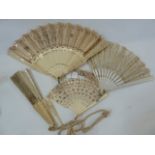 A pierced bone and silk fan, with silver sequinned decoration, the pierced sticks with silver