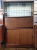 Mid 20th century teak lounge unit with two glazed sliding doors above cocktail cabinet fall, sliding