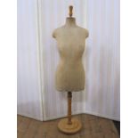 Vintage mannequin, the body covered in fabric, on a wooden adjustable stand (base and top may have