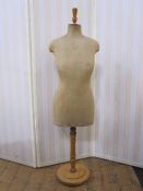 Vintage mannequin, the body covered in fabric, on a wooden adjustable stand (base and top may have