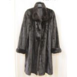 Black vintage fur coat, possibly sable, three-quarter length, cuff sleeves and a single button at