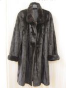 Black vintage fur coat, possibly sable, three-quarter length, cuff sleeves and a single button at