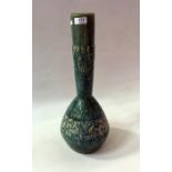 An Aw Eng Kwang pottery studio bottle vase, green glazed, Oriental town scene relief to bottle neck,