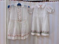 Child's dress with red, yellow and blue embroidery, mother-of-pearl buttons and another with