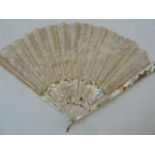 A 19th century mother of pearl and lace fan, one side the mother of pearl floral decorated with gilt