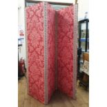 Three fold screen, covered in red damask, with red and gold braid detail